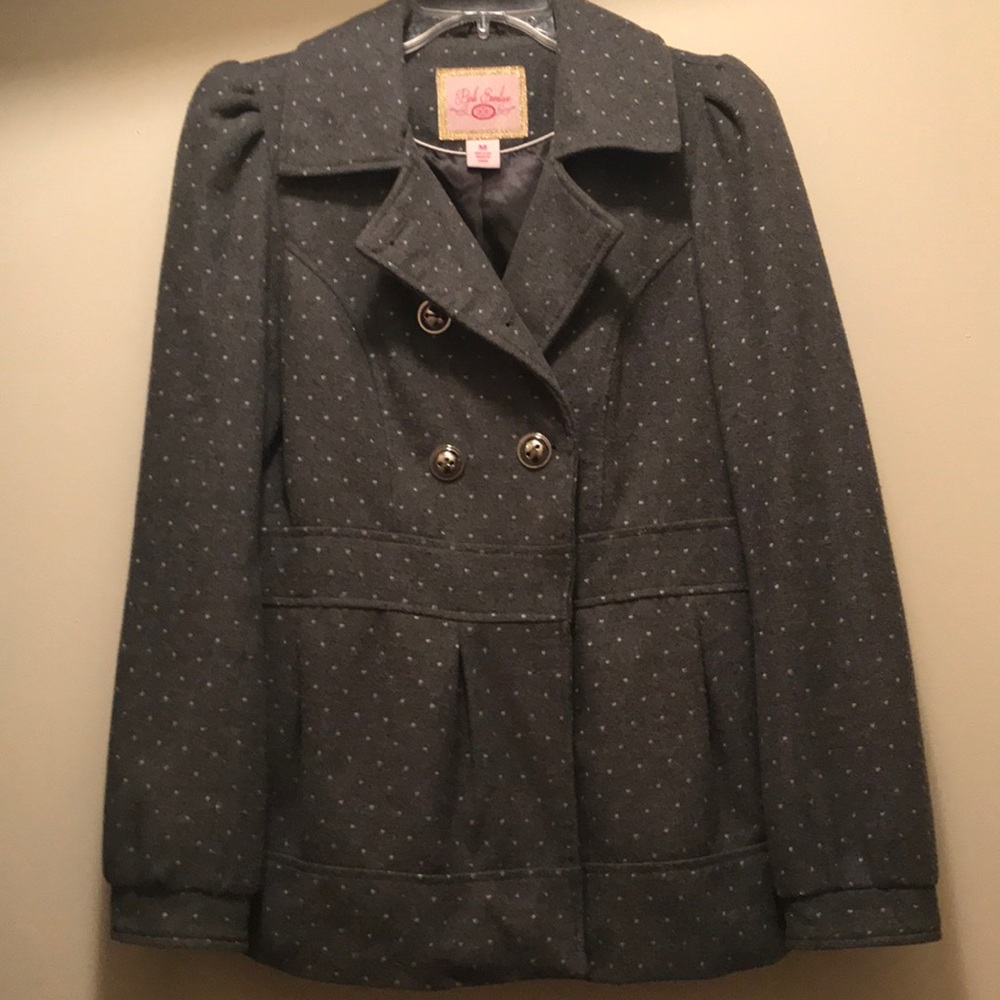 Gray jacket with white polka dots.